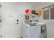 Laundry room featuring front-load washer and dryer, and a shelf for storage at 10723 N 118Th Way, Scottsdale, AZ 85259