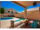 Covered patio area with a rug, picnic table, and built-in benches, great for outdoor entertaining at 10723 N 118Th Way, Scottsdale, AZ 85259