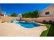 Backyard pool with spa and waterfall feature is surrounded by well manicured landscaping at 10723 N 118Th Way, Scottsdale, AZ 85259