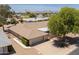 A high angle view of the exterior showing the roof, two-car garage, and nearby trees and community at 12831 W Maplewood Dr, Sun City West, AZ 85375