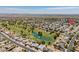 Stunning aerial view of a Primary-planned community bordering a golf course and water feature at 12831 W Maplewood Dr, Sun City West, AZ 85375