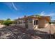 Back of house showcasing Arizona room with lots of light and low maintenance gravel landscaping at 12831 W Maplewood Dr, Sun City West, AZ 85375
