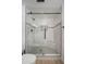 Stunning bathroom featuring a glass shower with marble tile and sleek black hardware at 12831 W Maplewood Dr, Sun City West, AZ 85375