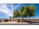 Charming single story home with a two-car garage, desert landscaping, and privacy wall in front at 12831 W Maplewood Dr, Sun City West, AZ 85375