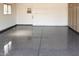 A spacious two car garage with epoxy flooring, ample storage, and natural light at 12831 W Maplewood Dr, Sun City West, AZ 85375