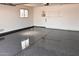 Spacious two car garage with epoxy flooring, window for natural light, and ample storage at 12831 W Maplewood Dr, Sun City West, AZ 85375