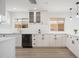 Clean kitchen with white cabinets, stainless-steel dishwasher, and quartz countertops at 12831 W Maplewood Dr, Sun City West, AZ 85375