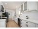Well-lit kitchen showcasing white cabinets, subway tile backsplash, and stainless appliances at 12831 W Maplewood Dr, Sun City West, AZ 85375