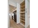 Open shelving within a spacious pantry in a kitchen with stainless appliances and white cabinets at 12831 W Maplewood Dr, Sun City West, AZ 85375