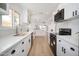 Bright kitchen features white cabinets, stainless steel appliances, and light countertops at 12831 W Maplewood Dr, Sun City West, AZ 85375
