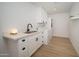 Laundry room with custom cabinets, sink, quartz countertop, and white washer and dryer at 12831 W Maplewood Dr, Sun City West, AZ 85375
