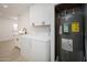 Utility room featuring a sink, storage cabinets, and a modern water heater at 12831 W Maplewood Dr, Sun City West, AZ 85375
