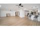 Bright living room featuring wood flooring, recessed lighting, and a breakfast bar at 12831 W Maplewood Dr, Sun City West, AZ 85375