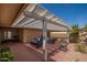 The covered patio is perfect for outdoor entertaining with ample seating and a stylish pergola at 12831 W Maplewood Dr, Sun City West, AZ 85375