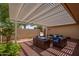 Enjoy outdoor living on this covered patio with ample seating, desert landscaping, and a stylish pergola at 12831 W Maplewood Dr, Sun City West, AZ 85375