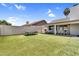 Expansive backyard featuring lush green turf and a charming covered patio, perfect for outdoor entertaining at 1320 E Scott Ave, Gilbert, AZ 85234