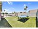 Backyard with a ping pong table, artificial grass, and privacy wall near a fenced pool area at 1320 E Scott Ave, Gilbert, AZ 85234