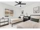 Inviting bedroom featuring two twin beds, decorative wall art, and a view through the window at 1320 E Scott Ave, Gilbert, AZ 85234