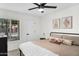 Bright bedroom featuring a modern ceiling fan and a beautifully designed bed with decorative pillows at 1320 E Scott Ave, Gilbert, AZ 85234