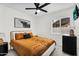 Cozy bedroom with decorative artwork and a view from the window, complemented by a comfortable bed at 1320 E Scott Ave, Gilbert, AZ 85234