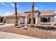 Charming single-story home featuring a tile roof, arched entryway, desert landscaping, and an attached two-car garage at 1320 E Scott Ave, Gilbert, AZ 85234