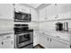 Well-equipped kitchen featuring stainless steel appliances, white cabinetry, and a functional layout for cooking and entertaining at 1320 E Scott Ave, Gilbert, AZ 85234