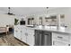 Modern kitchen with sleek white countertops and cabinets and stainless steel appliances and open to the living area at 1320 E Scott Ave, Gilbert, AZ 85234