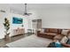 Spacious living room featuring dark wood flooring, a neutral color scheme, a ceiling fan, and lots of natural light at 1320 E Scott Ave, Gilbert, AZ 85234