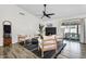 Stylishly furnished living room with a fireplace, wood floors, modern decor, and access to an outdoor patio at 1320 E Scott Ave, Gilbert, AZ 85234