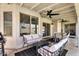 Covered outdoor patio featuring comfortable furniture, a ceiling fan, and access to the backyard at 1320 E Scott Ave, Gilbert, AZ 85234