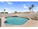 Sparkling private pool with baja shelf and in-pool seating is surrounded by mature palm trees at 1320 E Scott Ave, Gilbert, AZ 85234