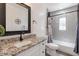 Updated bathroom featuring granite countertops, subway tile in the shower, and modern fixtures at 1322 W Flower St, Phoenix, AZ 85013