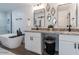 Beautiful bathroom with a tub, double vanities with granite countertops, and modern black fixtures at 1322 W Flower St, Phoenix, AZ 85013