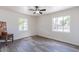 Cozy bedroom with wood-look tile floors, two windows providing natural light, and a ceiling fan at 1322 W Flower St, Phoenix, AZ 85013