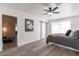 Bright bedroom featuring wood-look tile flooring, a ceiling fan, and a sliding barn door at 1322 W Flower St, Phoenix, AZ 85013