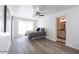 Inviting bedroom features wood-look floors, ceiling fan, and an ensuite bathroom at 1322 W Flower St, Phoenix, AZ 85013