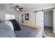 Comfortable bedroom with a ceiling fan and barn door leading to the closet at 1322 W Flower St, Phoenix, AZ 85013