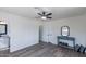 Spacious bedroom featuring tile floors, ceiling fan, and ensuite bathroom at 1322 W Flower St, Phoenix, AZ 85013