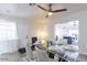 Bright dining room with ceiling fan, glass table set for four, and open access to the living room at 1322 W Flower St, Phoenix, AZ 85013