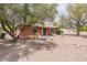 Charming single-story brick home with a mature tree and gravel landscaping at 1322 W Flower St, Phoenix, AZ 85013