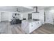 Open concept kitchen with island cooktop, granite counters, and stainless hood, open to living area at 1322 W Flower St, Phoenix, AZ 85013