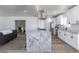 View of the gourmet kitchen with granite countertops and stainless steel appliances flowing into the living room at 1322 W Flower St, Phoenix, AZ 85013