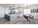 Well-lit kitchen with a large island, modern light fixture, and bright white cabinetry at 1322 W Flower St, Phoenix, AZ 85013