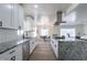 Spacious kitchen with granite counters, stainless steel appliances, and center island cooktop at 1322 W Flower St, Phoenix, AZ 85013