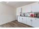 Well-lit kitchenette featuring white cabinets and granite countertops at 1322 W Flower St, Phoenix, AZ 85013