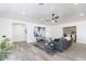 Bright living room with a gray couch, area rug, ceiling fan, and hardwood floors at 1322 W Flower St, Phoenix, AZ 85013