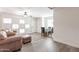 Cozy living room featuring a comfortable leather sofa and ceiling fan at 1322 W Flower St, Phoenix, AZ 85013