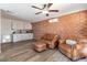 Inviting living room featuring exposed brick wall, comfortable seating, and a convenient kitchenette at 1322 W Flower St, Phoenix, AZ 85013