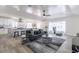 Bright living room featuring hardwood floors, modern furniture, and an open concept kitchen area at 1322 W Flower St, Phoenix, AZ 85013