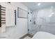 Elegant bathroom shower with marble-look tile, a glass door, and a sleek black showerhead and controls at 1322 W Flower St, Phoenix, AZ 85013